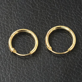 Pair of gold hoop earrings on a black textured background