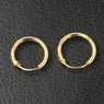Pair of gold hoop earrings on a black textured background