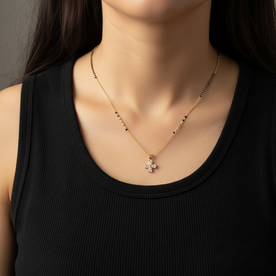 Necklace with a floral pendant worn by a person in a black top
